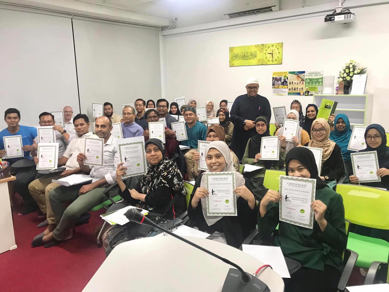 Participants holding certificates after an AtTartilQI recitation course